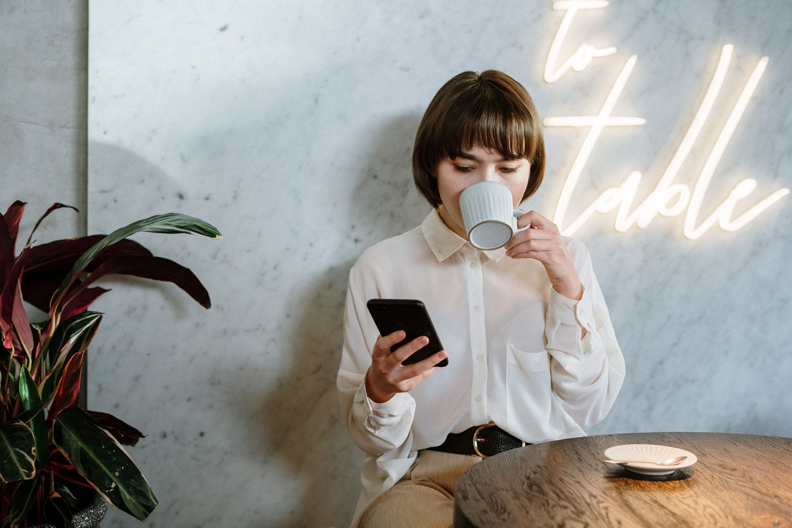 A woman using her phone in a café