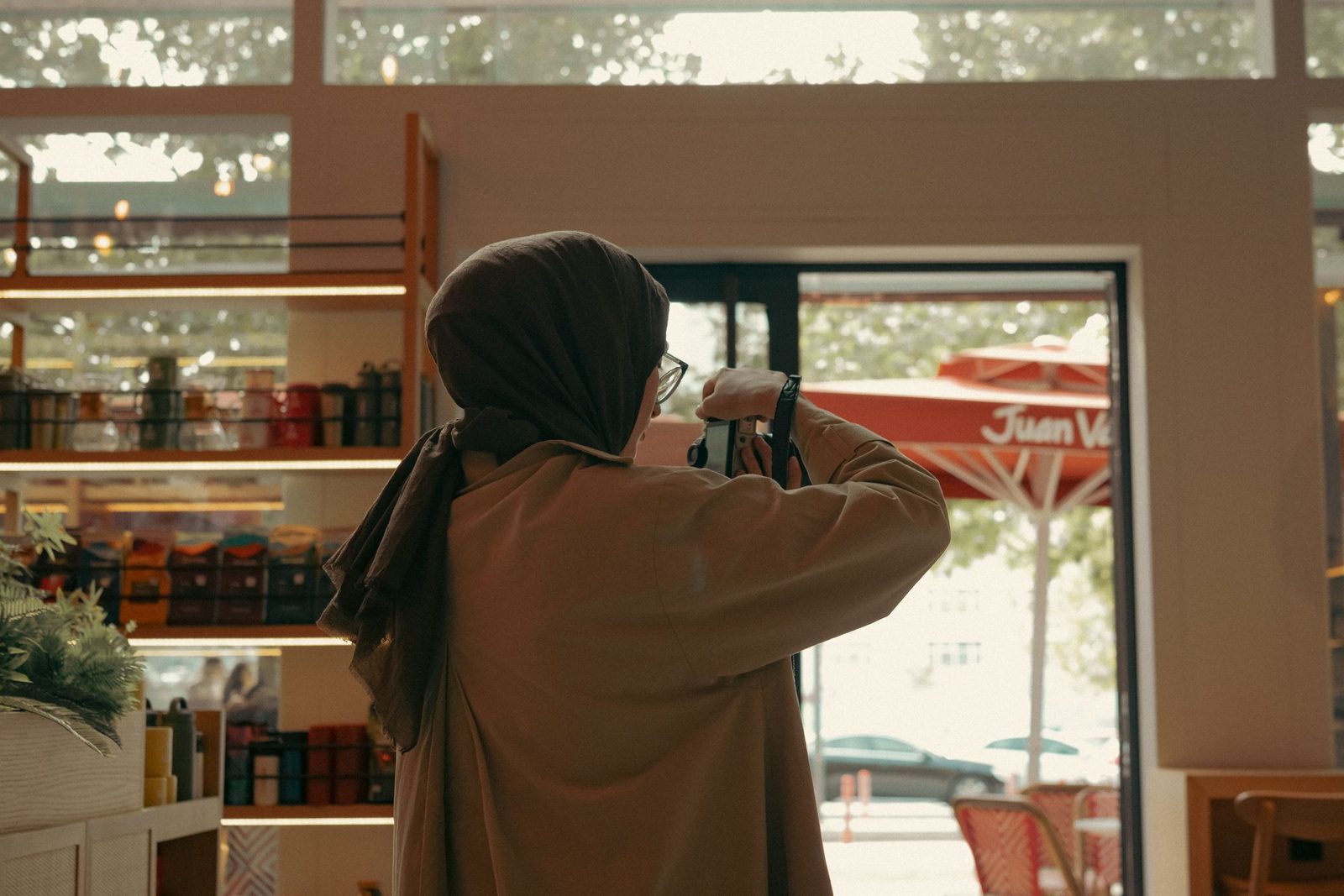 A woman photographing the inside of a café