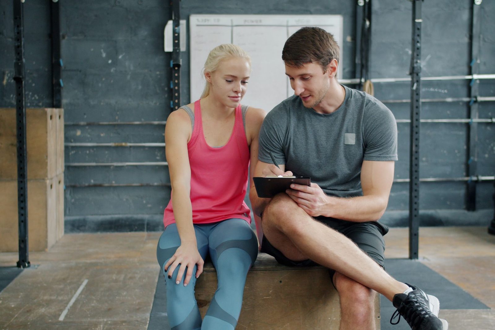 A personal trainer going through a workout plan with a client