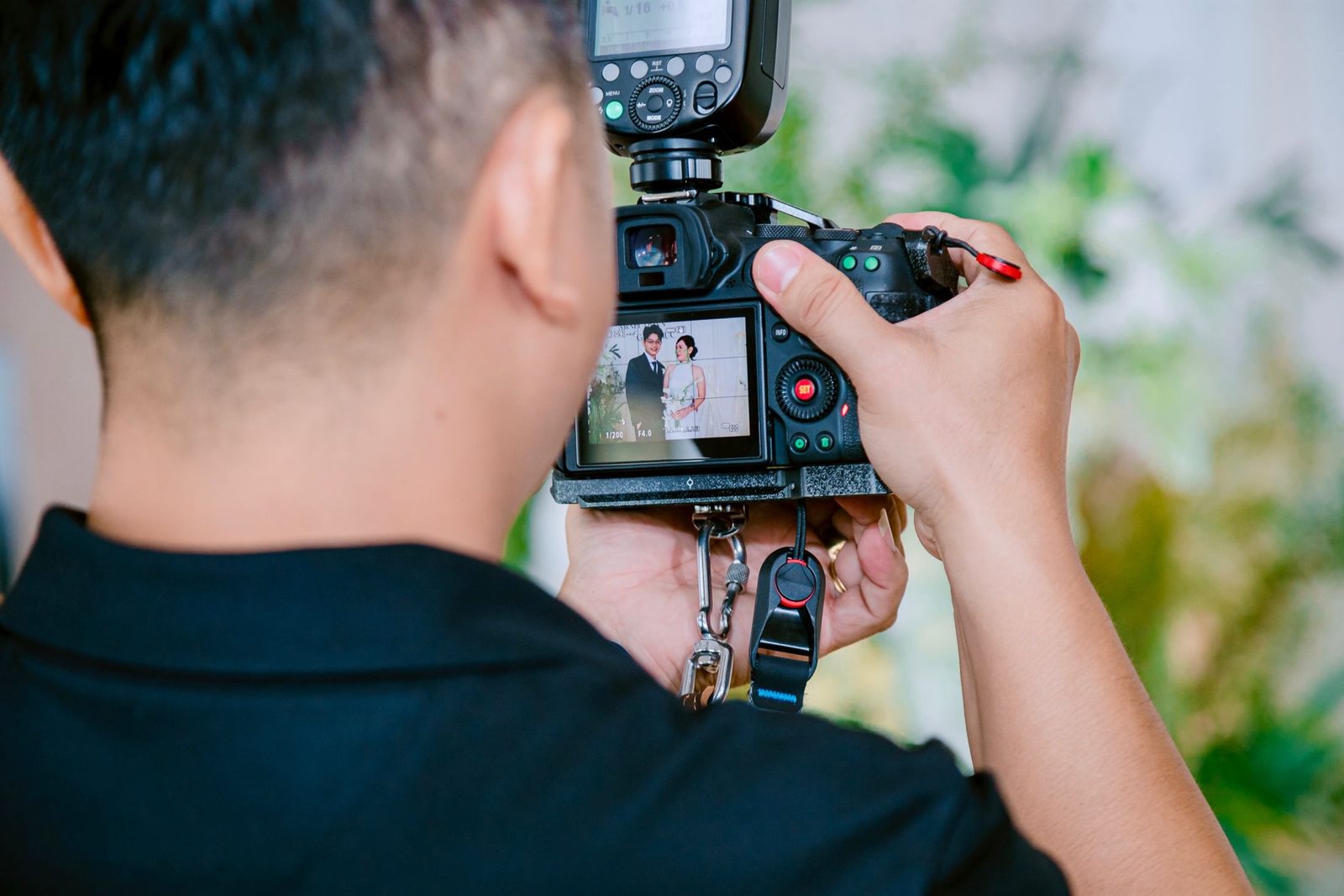 A photographer taking pictures of a wedding couple