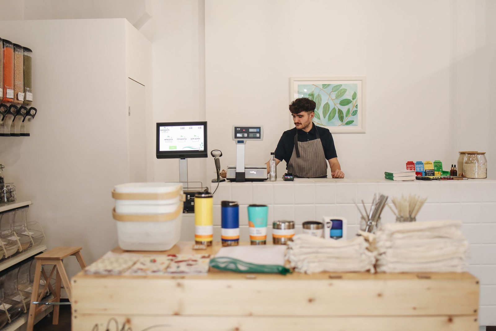 A shop owner working at the counter of his shop