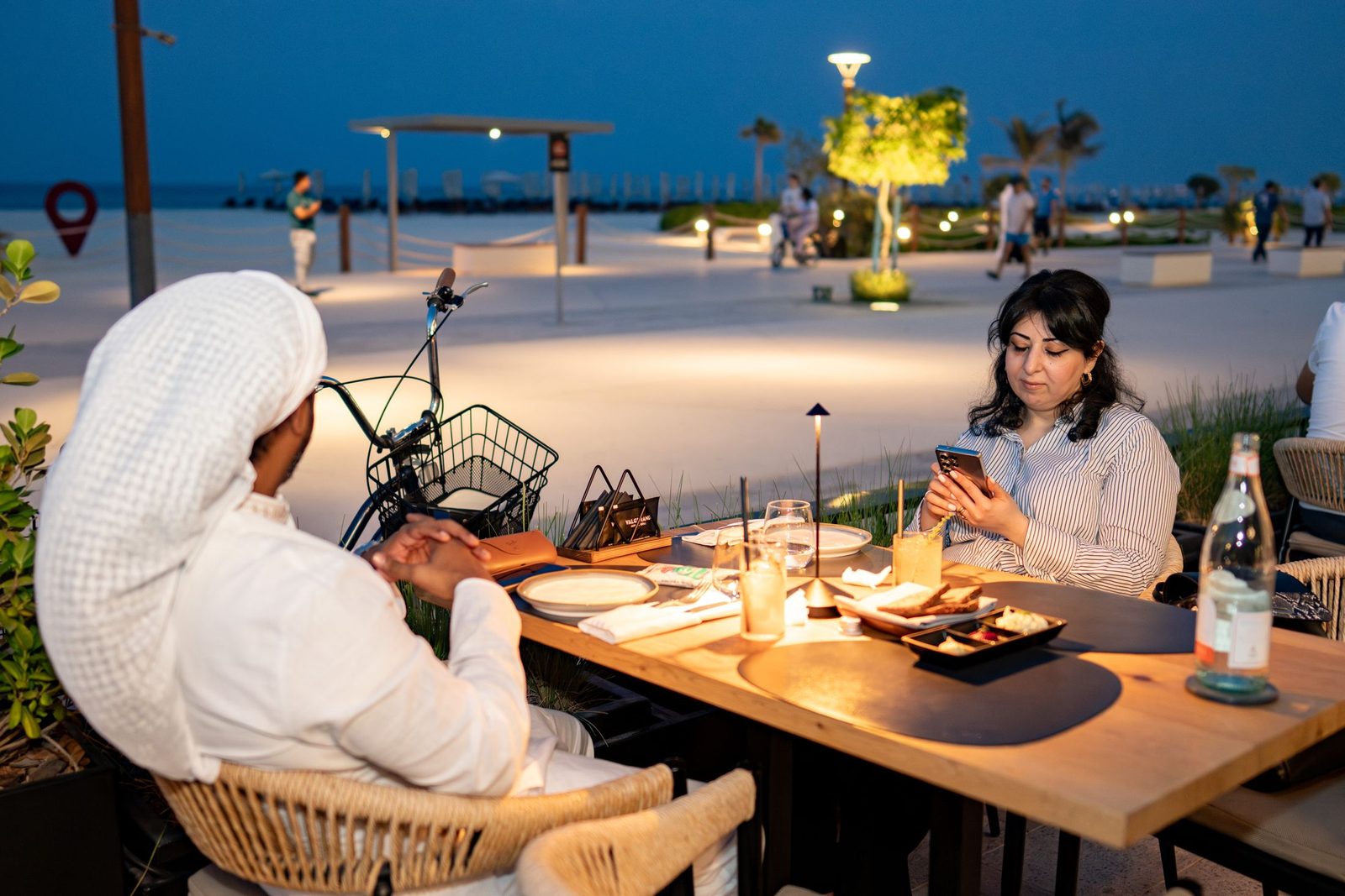 Two people having dinner at a beachfront restaurant