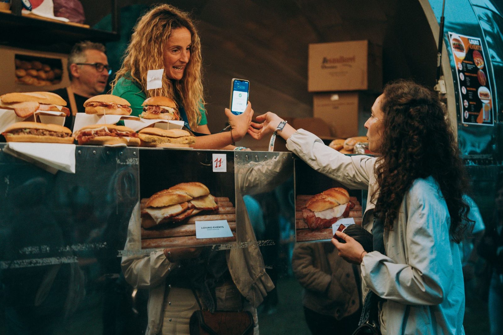 A customer paying by phone at a food truck