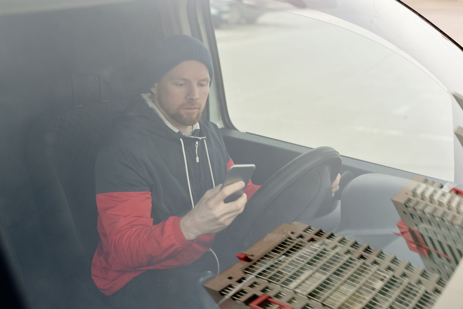 A man sitting in his van using his phone