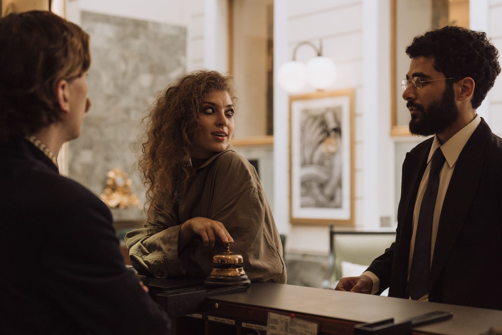 Guests talking to staff at a hotel reception desk